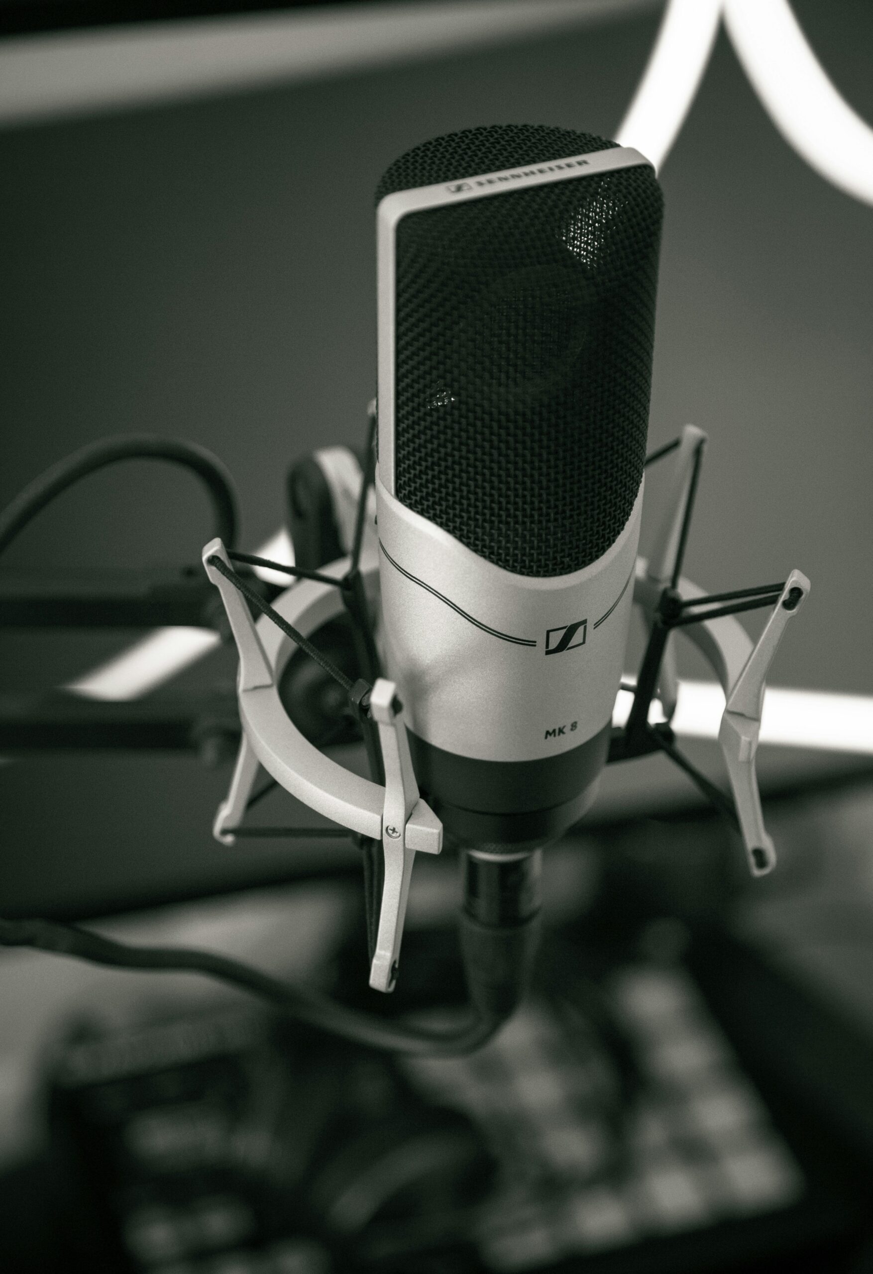 Close-up of a sleek microphone setup in a modern recording studio, capturing sound with precision.